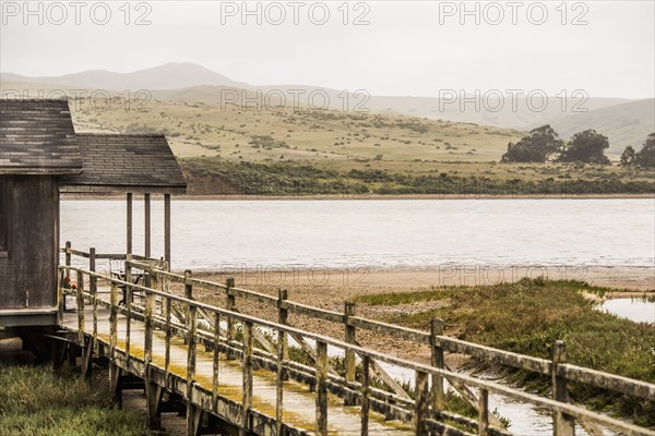 Wooden walkway at rural lake