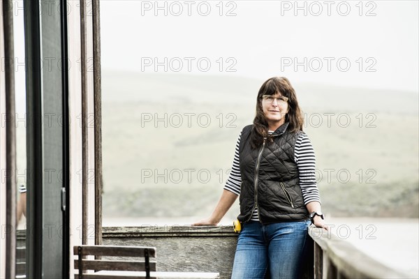 Caucasian woman standing on balcony