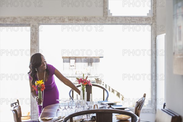Woman setting dining table