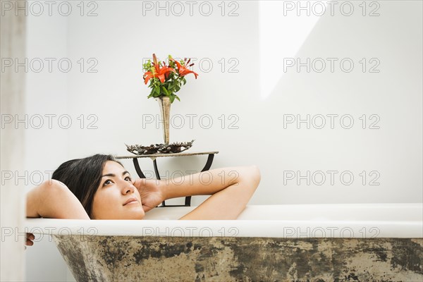 Woman relaxing in bubble bath