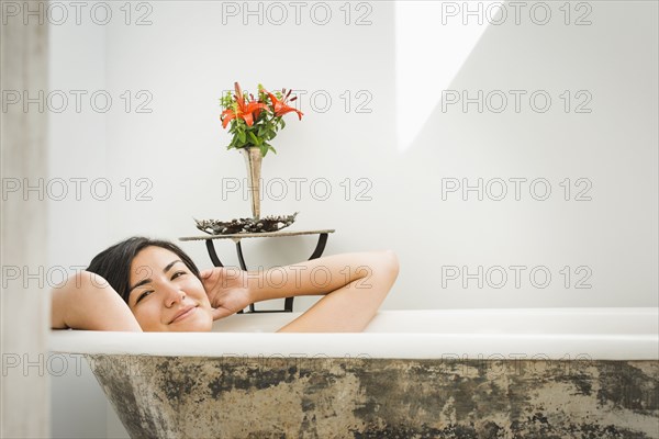 Woman relaxing in bubble bath