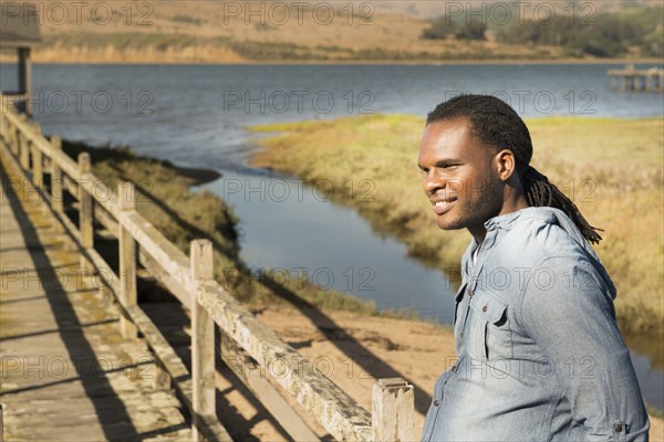 African American man standing on wooden deck