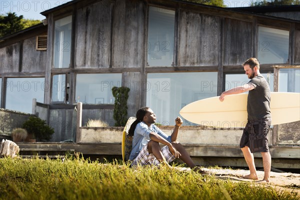 Men with surfboards outdoors