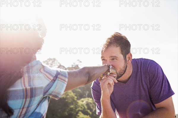 Man kissing hand of girlfriend