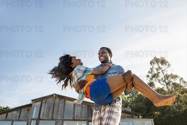 African American man carrying girlfriend