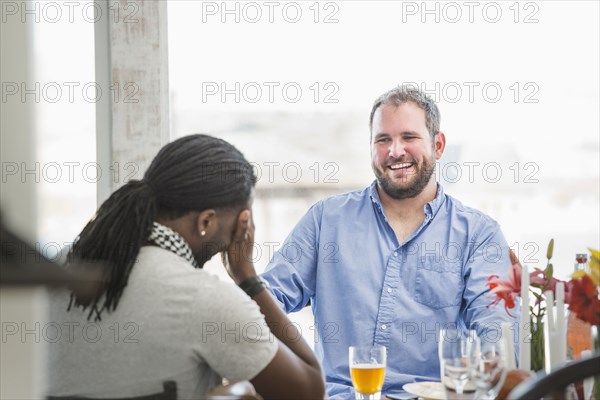 Men laughing at dinner table