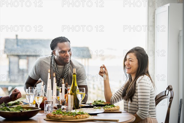 Couple talking at dinner party
