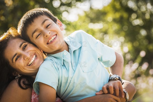 Mother and son hugging outdoors