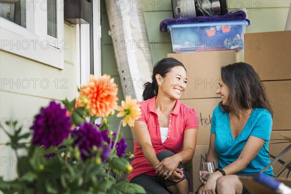 Women smiling outside house