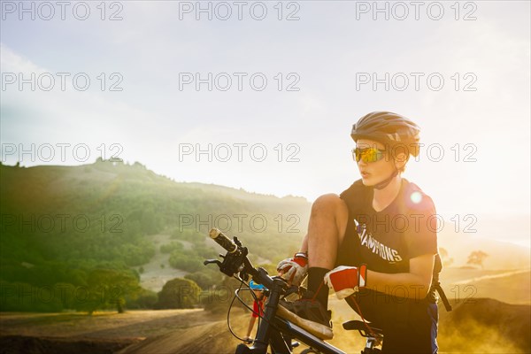 Caucasian boy riding dirt bike outdoors