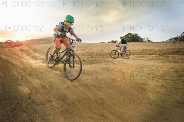 Boy riding dirt bikes on track