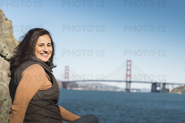 Mixed race woman smiling near Golden Gate Bridge view