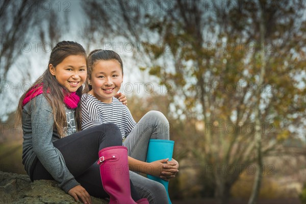 Mixed race sisters smiling outdoors