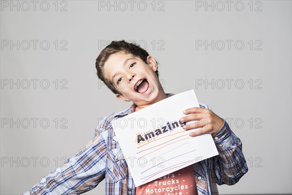 Proud Mixed Race boy holding awesome sign