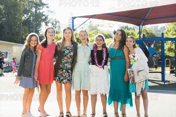 Proud well-dressed girls posing on playground