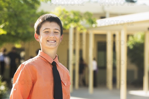 Proud Caucasian boy posing outdoors