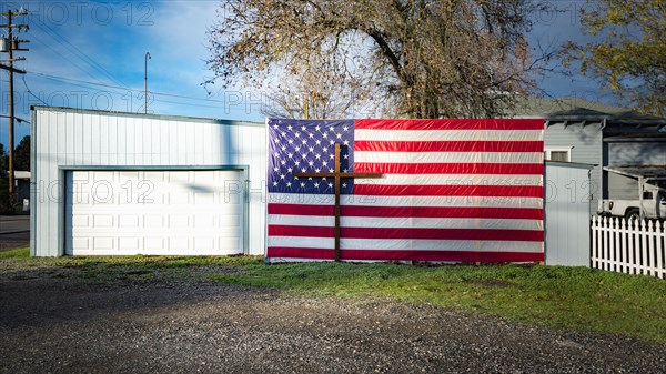 Crucifix and American flag at garage