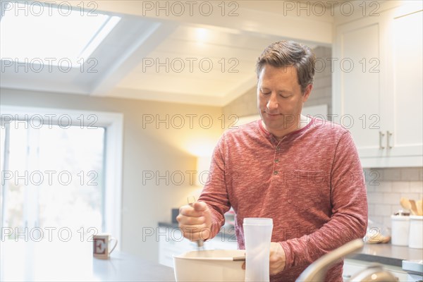 Caucasian man mixing food in bowl