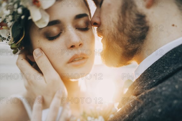 Caucasian bride and groom on sunny day