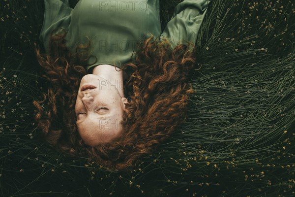 Caucasian girl sleeping in grass