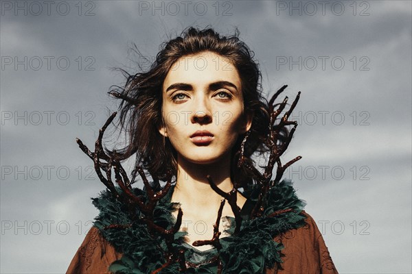 Caucasian woman wearing branch necklace