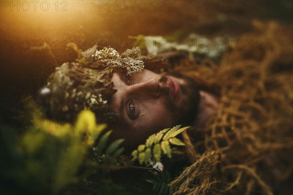 Caucasian man laying in grass