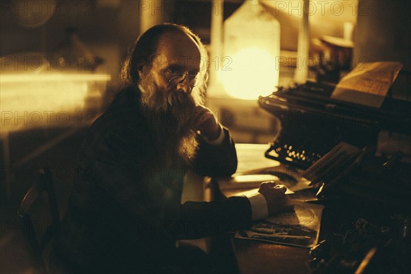 Caucasian man with beard reading book