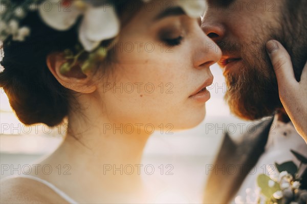 Caucasian bride and groom kissing