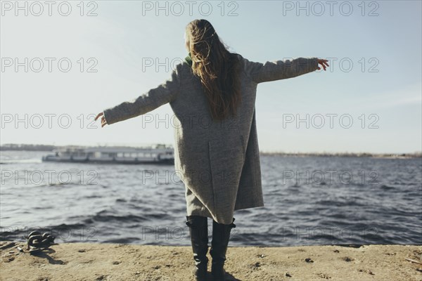 Caucasian woman standing near ocean