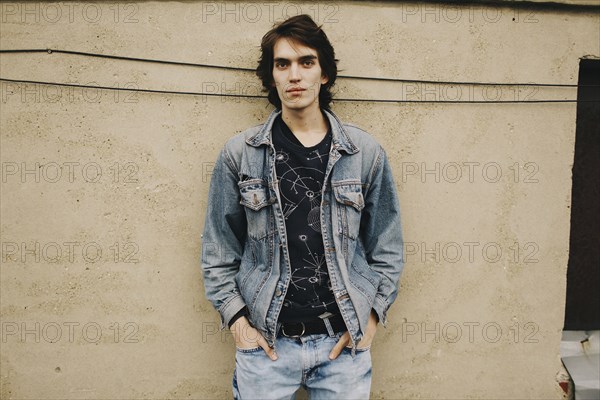 Portrait of Caucasian man leaning on wall