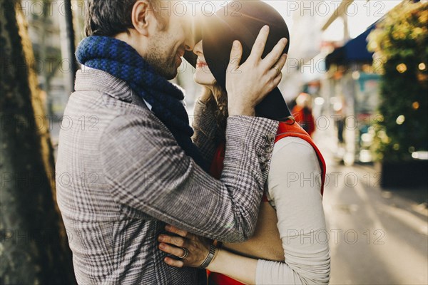 Caucasian couple rubbing noses on sunny day