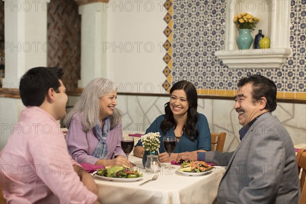 Couples laughing in restaurant