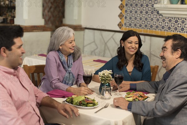 Couples laughing in restaurant