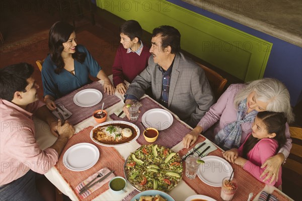 High angle view of family enjoying dinner in restaurant