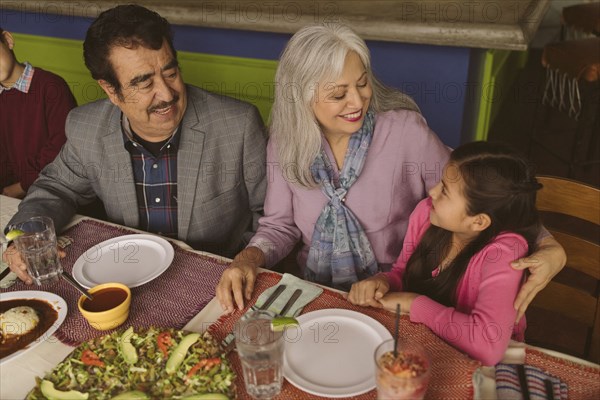 High angle view of grandparents and grandchildren in restaurant