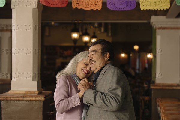 Older couple dancing in restaurant