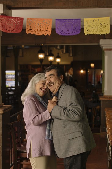 Older couple dancing in restaurant