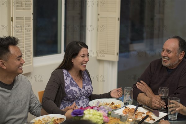 People laughing at dinner table