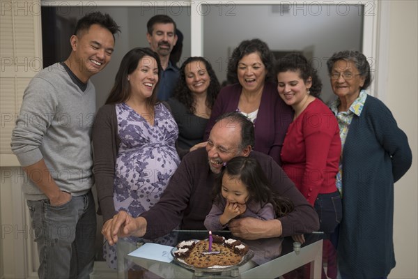Multi-generation family celebrating birthday of older man