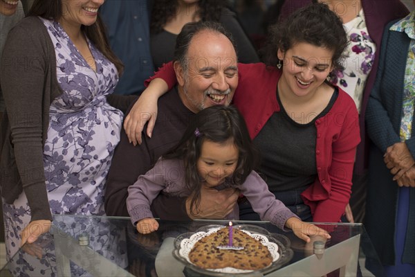 Multi-generation family celebrating birthday of older man