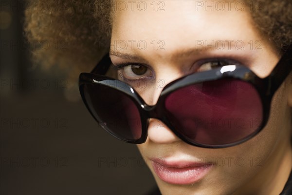 Close up of mixed race woman wearing sunglasses