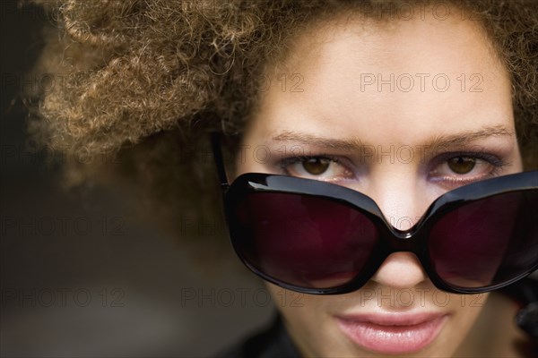 Close up of mixed race woman wearing sunglasses