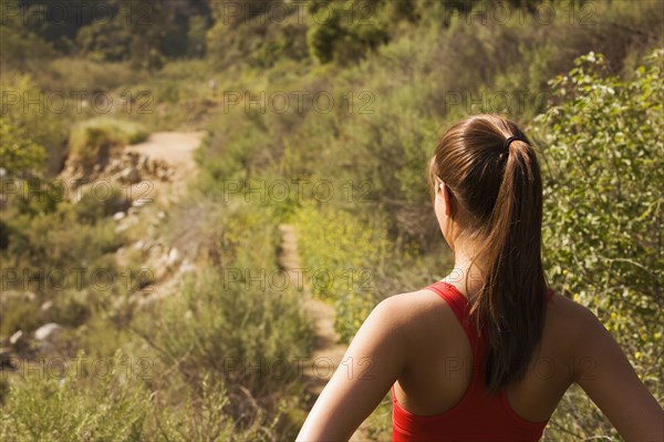 Hispanic woman looking at nature trail