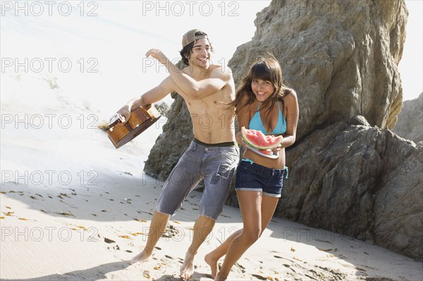 Man with guitar teasing girlfriend