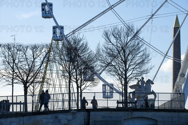 People walking near ferris wheel in Paris