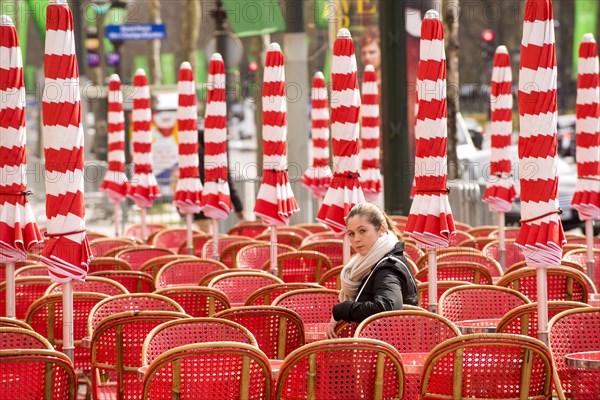 Girl sitting in red chair looking over shoulder