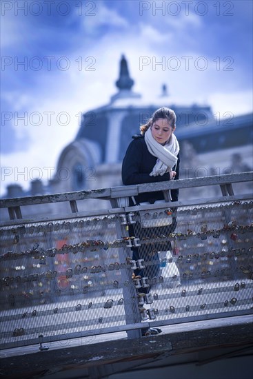 Girl looking over bridge railing