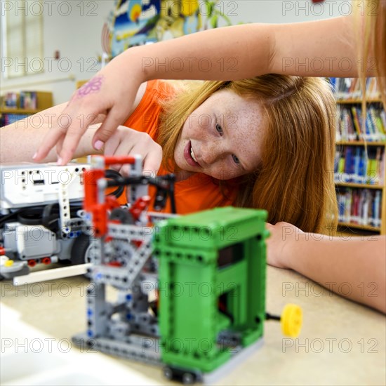 Girls assembling plastic blocks in library