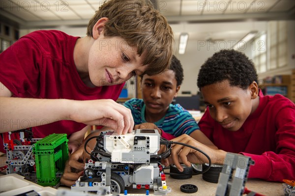 Boys assembling plastic blocks in library