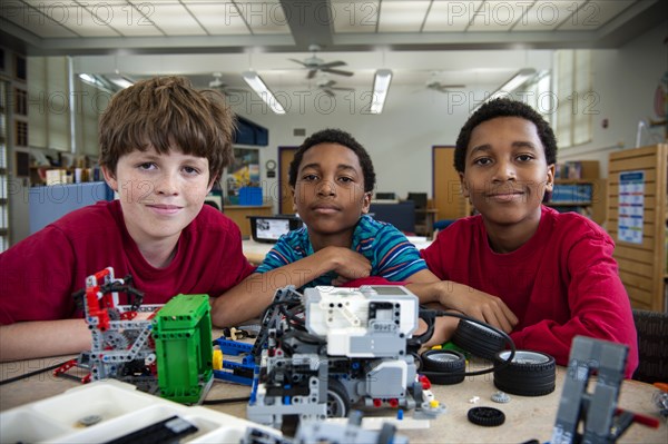 Boys posing with plastic blocks in library